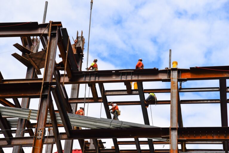 Construction workers on steel beams in construction site of skyscraper in New York